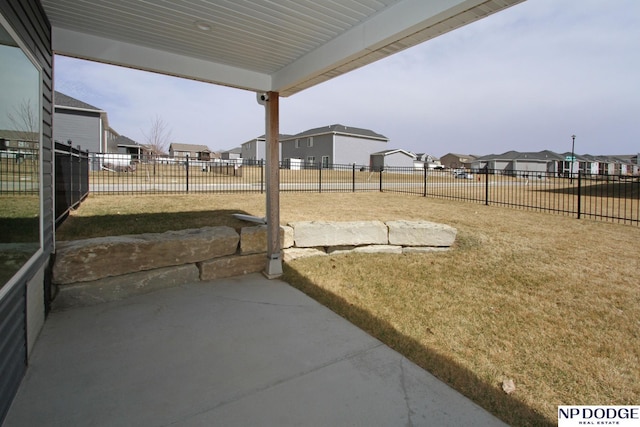 view of yard featuring a residential view, a fenced backyard, and a patio area