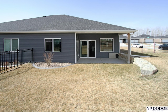 back of house with a patio area, a yard, fence, and a shingled roof