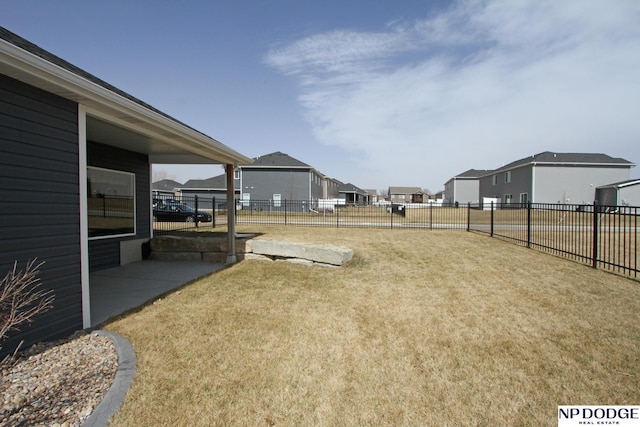 view of yard featuring a residential view and fence