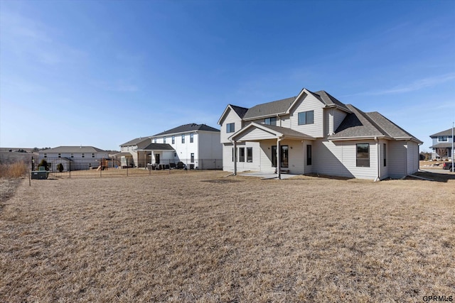 17205 Sarah St, Bennington, NE 68007 - rear view of house with a patio area, a shingled roof, a yard, and fence