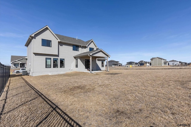 17205 Sarah St, Bennington, NE 68007 - back of property featuring central AC unit, fence, and a lawn