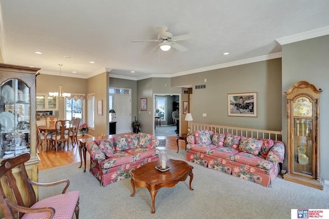 living room with recessed lighting, visible vents, ornamental molding, and ceiling fan with notable chandelier