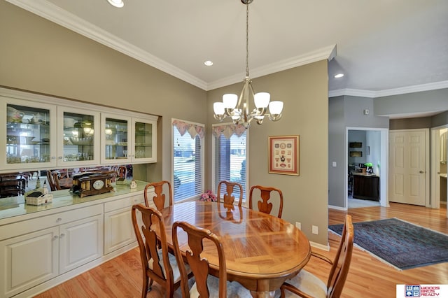 dining area featuring baseboards, recessed lighting, ornamental molding, light wood-style floors, and a chandelier