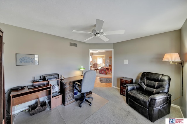 office area with visible vents, baseboards, and ceiling fan