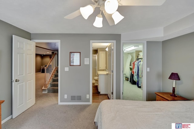 bedroom featuring baseboards, visible vents, a spacious closet, a closet, and carpet flooring