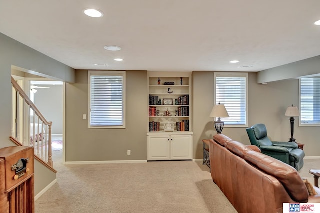 living area featuring stairs, recessed lighting, baseboards, and light carpet