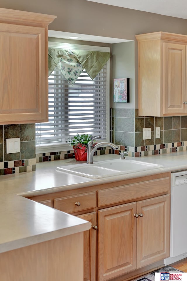 kitchen with a sink, decorative backsplash, dishwasher, and light brown cabinets