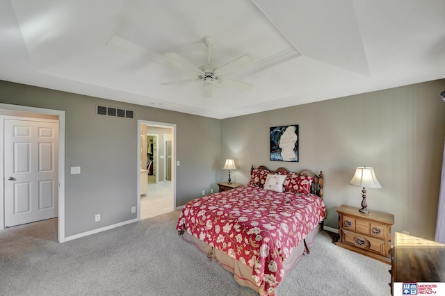 bedroom featuring baseboards, visible vents, carpet floors, ceiling fan, and a raised ceiling