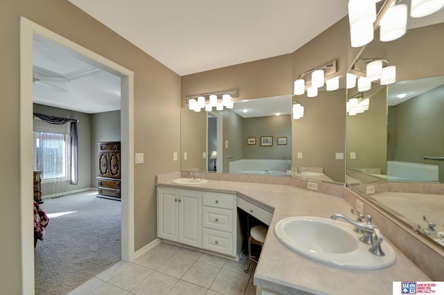 full bathroom with tile patterned floors, double vanity, a bath, and a sink