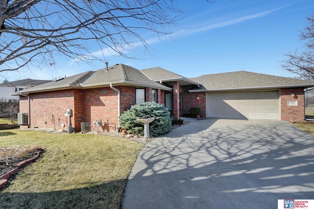 ranch-style house with a front yard, cooling unit, driveway, an attached garage, and brick siding