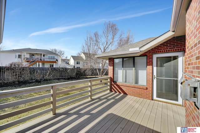 wooden deck featuring a residential view and fence