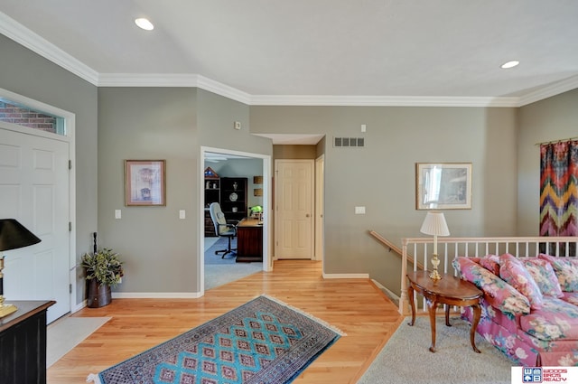 interior space featuring recessed lighting, baseboards, crown molding, and light wood finished floors