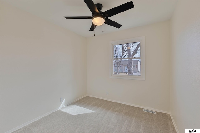 unfurnished room featuring visible vents, light colored carpet, baseboards, and ceiling fan