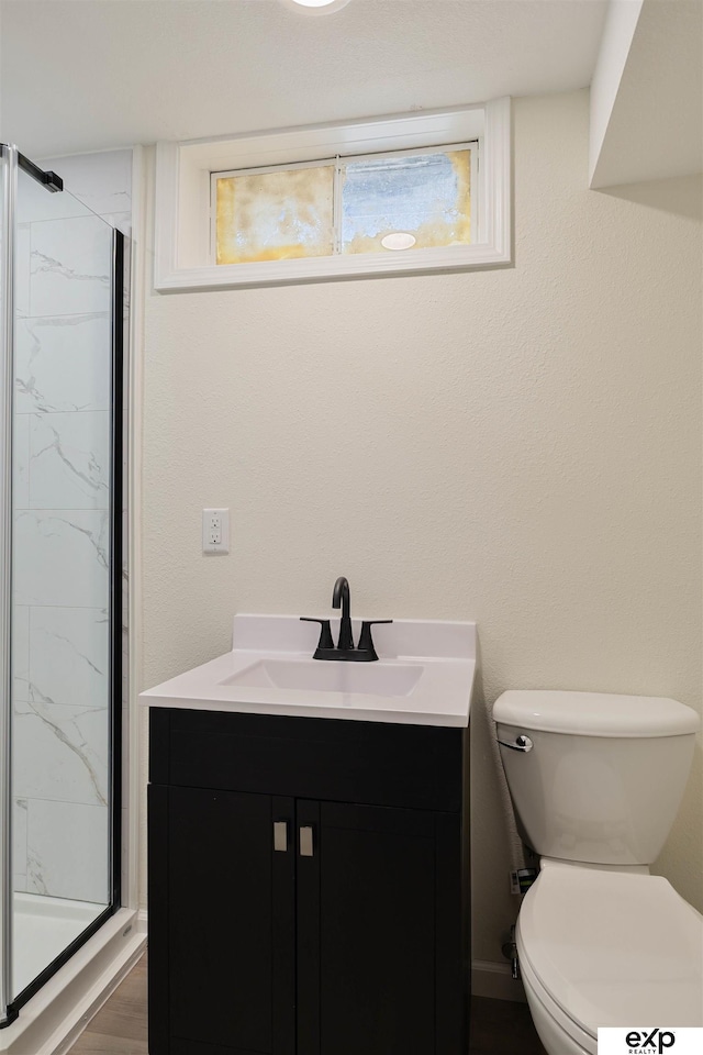 full bath with vanity, toilet, and a stall shower