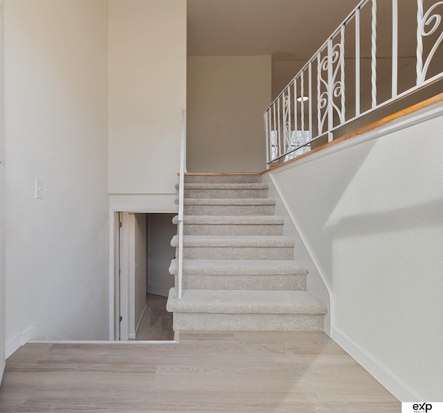 stairs featuring baseboards and wood finished floors