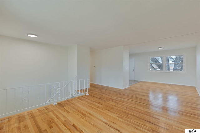 unfurnished room featuring light wood-style flooring and baseboards