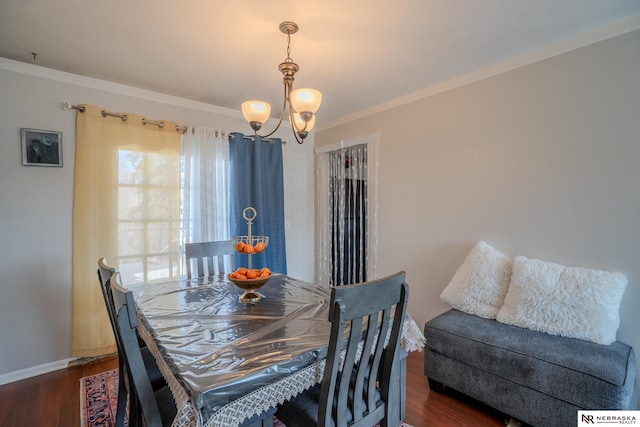 dining area featuring ornamental molding, baseboards, an inviting chandelier, and wood finished floors