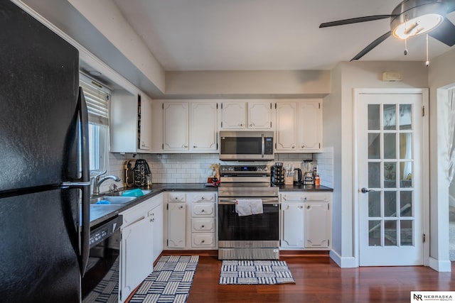 kitchen featuring ceiling fan, black appliances, dark countertops, and a sink