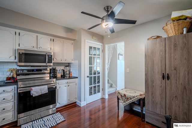 kitchen featuring dark wood-style flooring, ceiling fan, stainless steel appliances, dark countertops, and tasteful backsplash