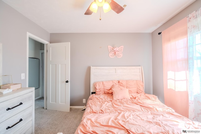 carpeted bedroom with baseboards and ceiling fan