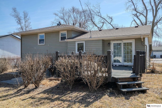 back of property featuring a wooden deck and a shingled roof