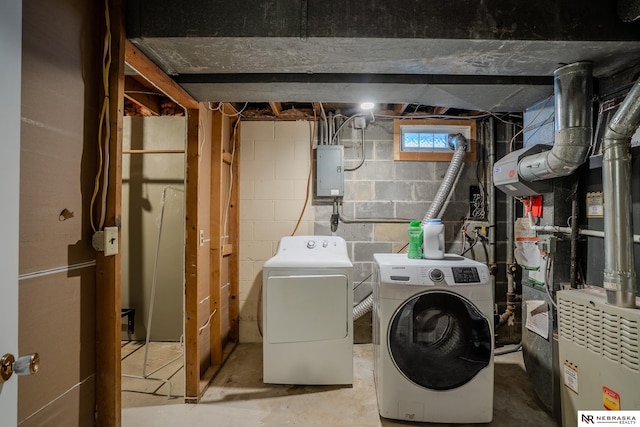 washroom featuring laundry area, electric panel, and separate washer and dryer