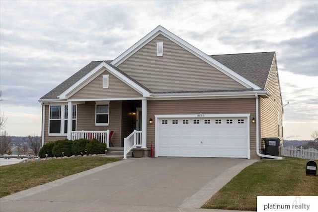 craftsman inspired home with driveway, an attached garage, a front lawn, a porch, and fence