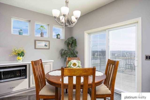 dining area featuring a notable chandelier and dark wood-style flooring
