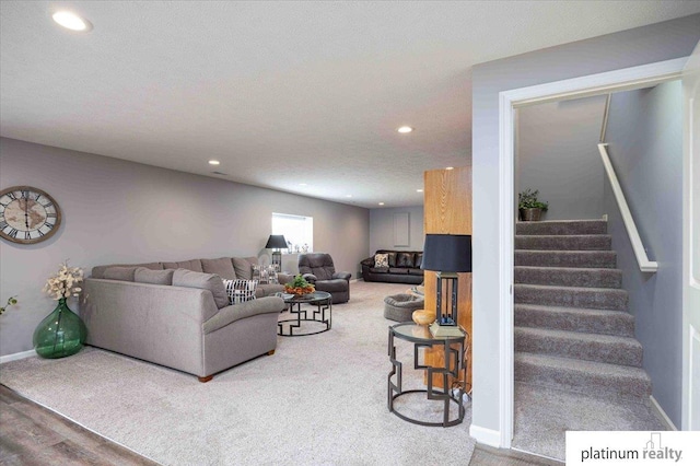 living area with recessed lighting, baseboards, carpet, and stairs