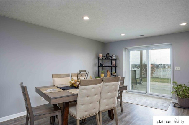 dining room with visible vents, baseboards, a textured ceiling, recessed lighting, and wood finished floors