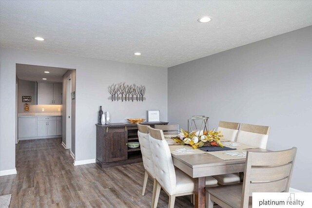 dining area featuring baseboards, recessed lighting, and wood finished floors