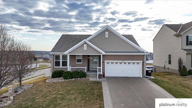 craftsman-style house featuring an attached garage, covered porch, concrete driveway, and a front lawn