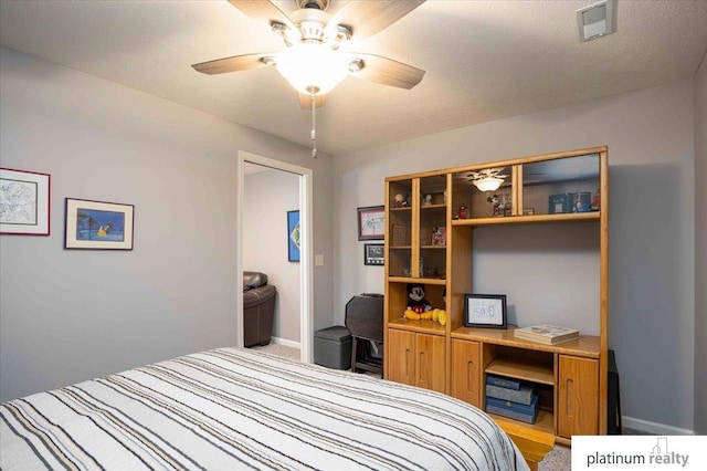 bedroom featuring carpet floors, baseboards, ceiling fan, and visible vents