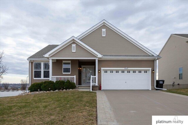 view of front of home featuring a porch, concrete driveway, a garage, and a front yard