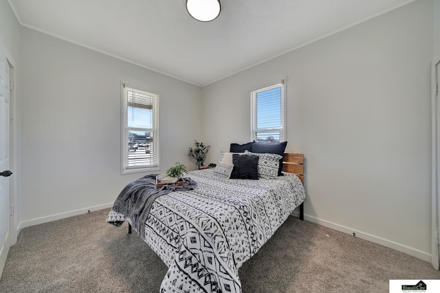 bedroom featuring multiple windows, carpet, baseboards, and ornamental molding