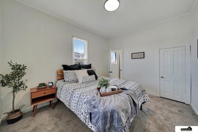 bedroom with crown molding, light colored carpet, and baseboards