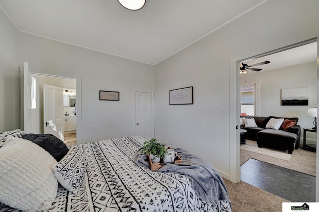 carpeted bedroom featuring baseboards and connected bathroom