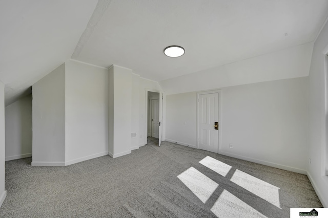 additional living space with baseboards, carpet, and lofted ceiling