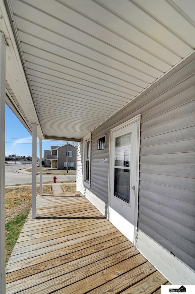 wooden terrace featuring covered porch