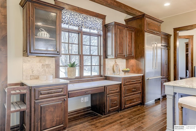 kitchen featuring a wealth of natural light, decorative backsplash, and dark wood-style floors