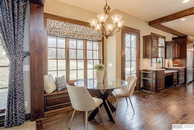 dining area featuring a notable chandelier, plenty of natural light, dark wood-type flooring, and beam ceiling