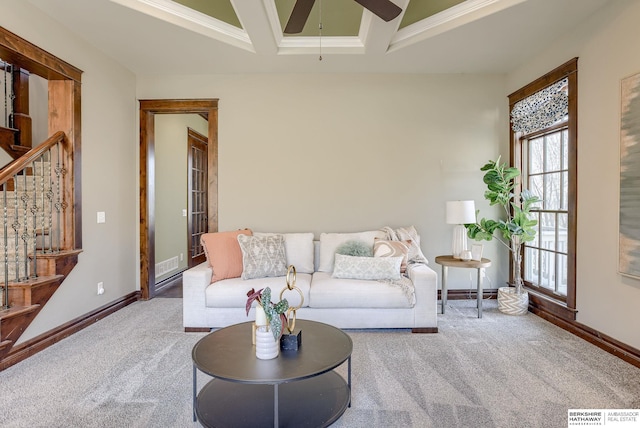 carpeted living area featuring visible vents, ornamental molding, coffered ceiling, baseboards, and ceiling fan