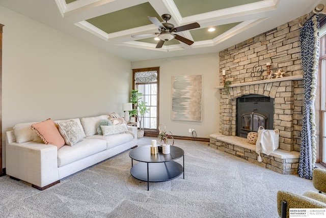 carpeted living area with beamed ceiling, a ceiling fan, coffered ceiling, a fireplace, and baseboards