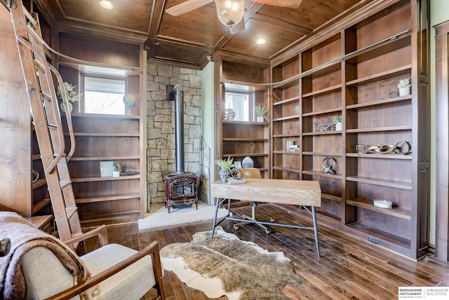 office with a ceiling fan, coffered ceiling, a wood stove, hardwood / wood-style flooring, and wood ceiling