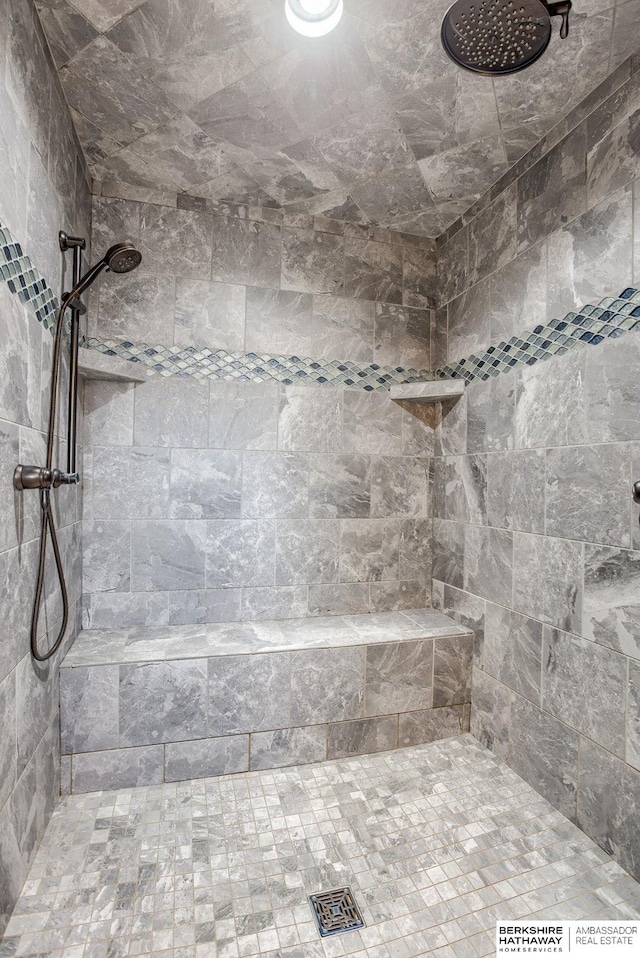 bathroom with a tile shower