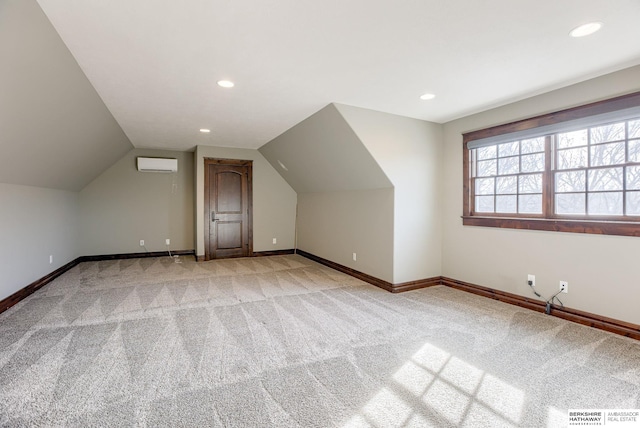 bonus room featuring baseboards, light colored carpet, a wall unit AC, vaulted ceiling, and recessed lighting