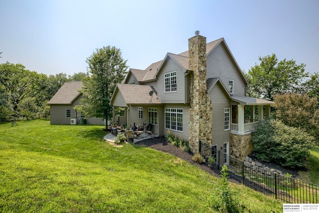 back of house with a patio, fence, a yard, a shingled roof, and a chimney