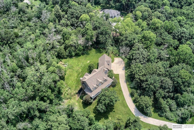 birds eye view of property with a wooded view