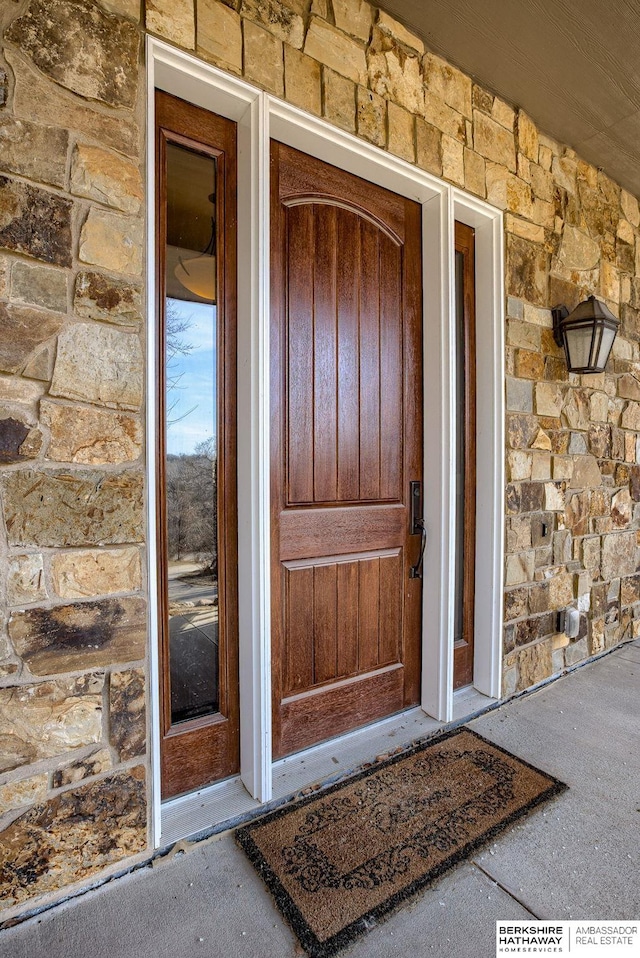 entrance to property with stone siding