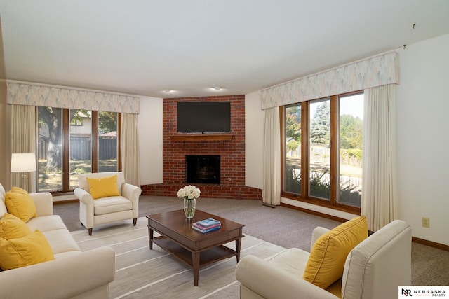 living area featuring a wealth of natural light, a fireplace, light carpet, and baseboards